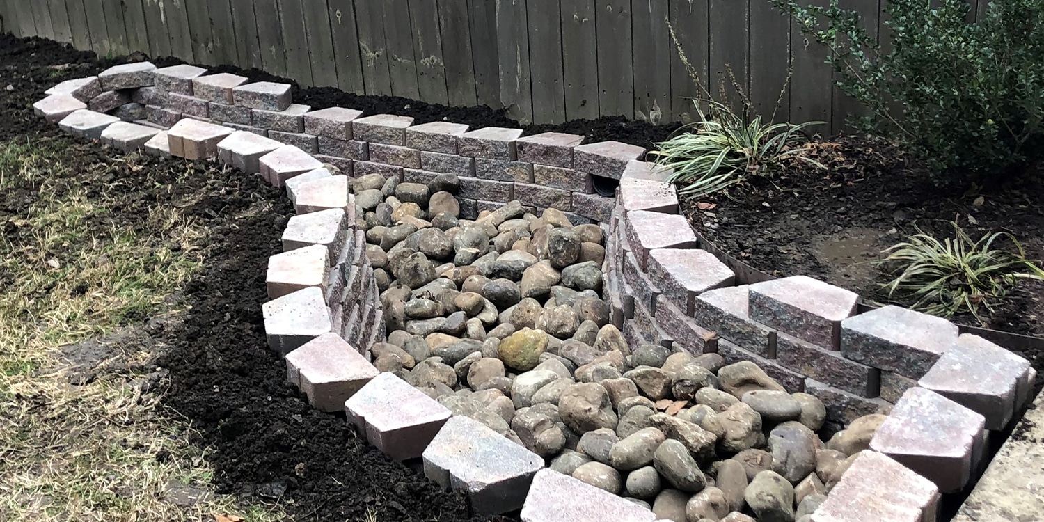 A stone drainage system designed and built by Opportunity Landscapes in Nashville, TN