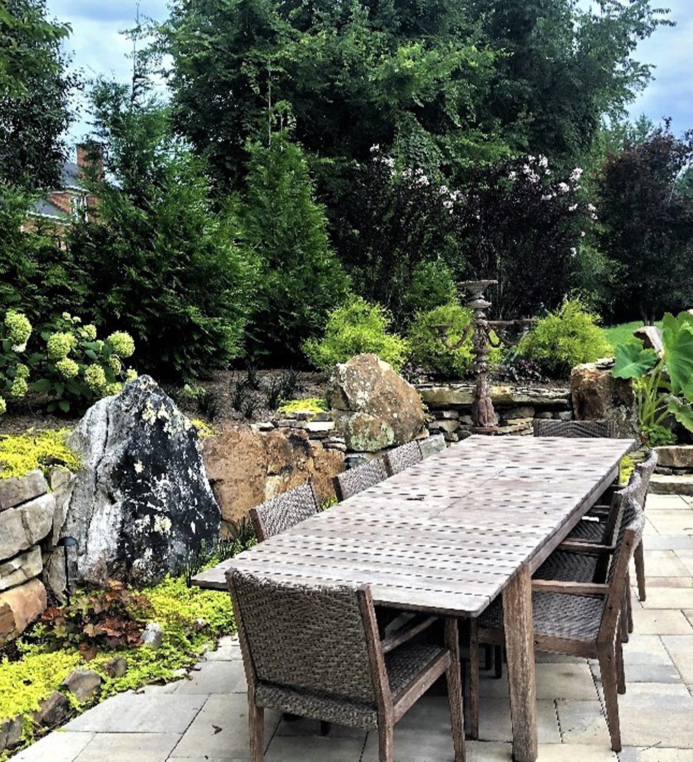 a stone bench in a garden