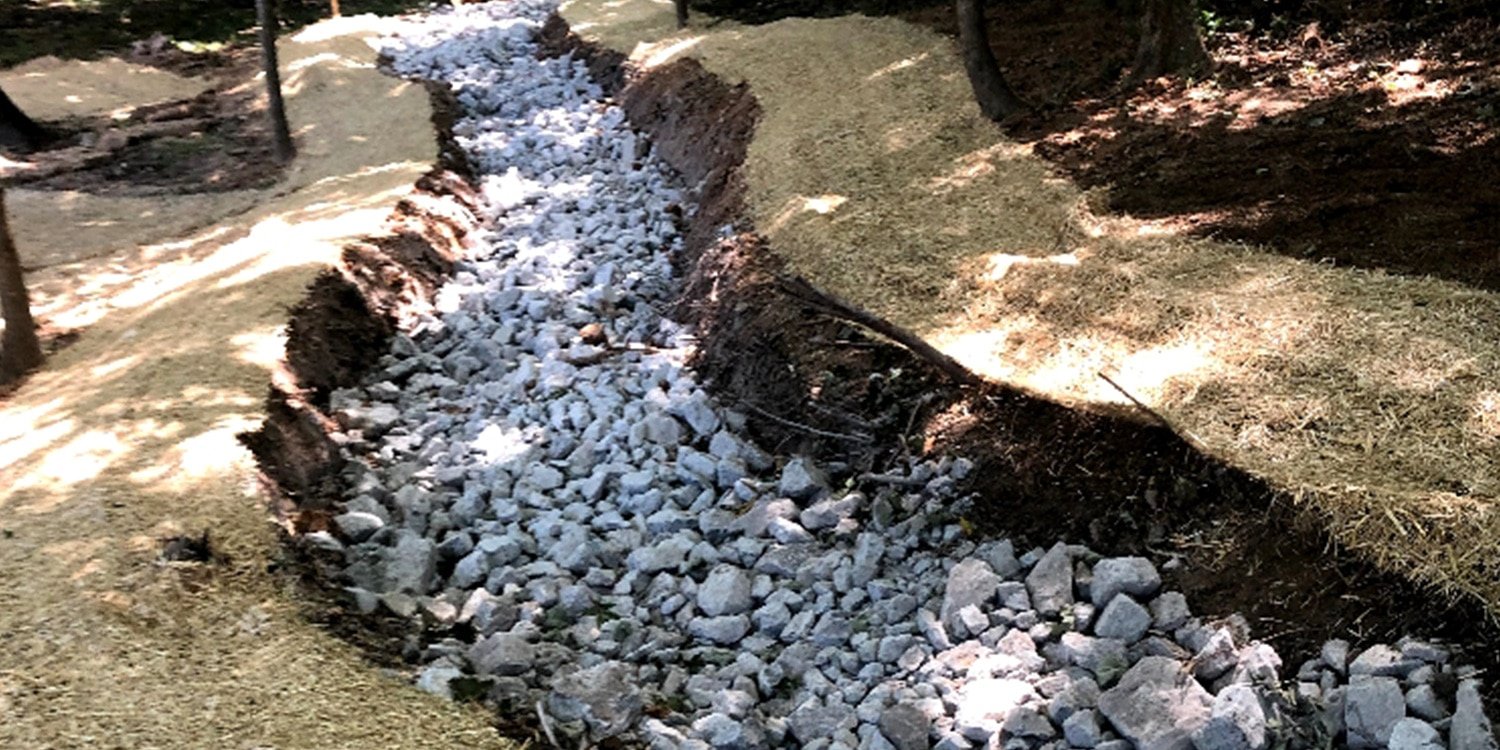 a pile of dirt in a rocky area